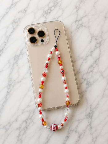 Cordon téléphone perles nacrées fleurs rouge sur smartphone