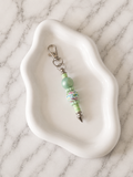 Porte-clés Perles Vert Pastel sur fond marbré
