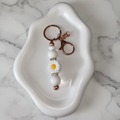 Porte-clés Marguerite Dorée - fond marbré